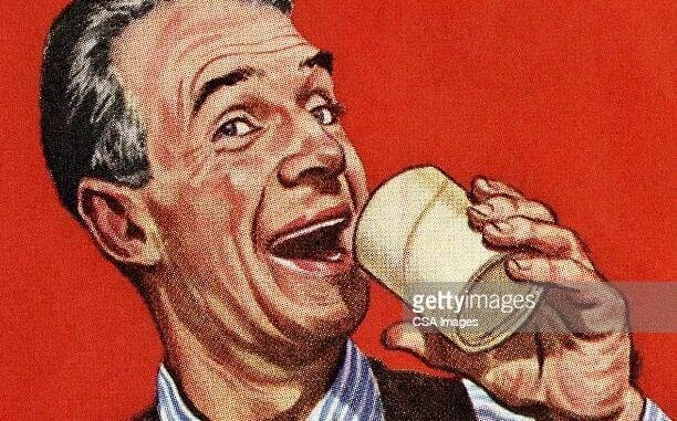Man Drinnking out of a Glass