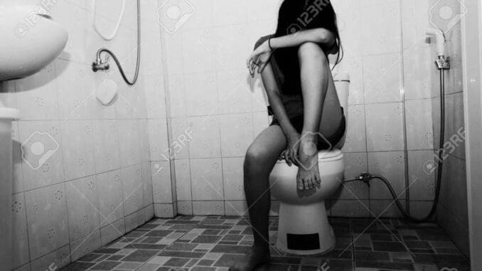 fear and depress girl sitting in toilet, white tone , Child abuse concept